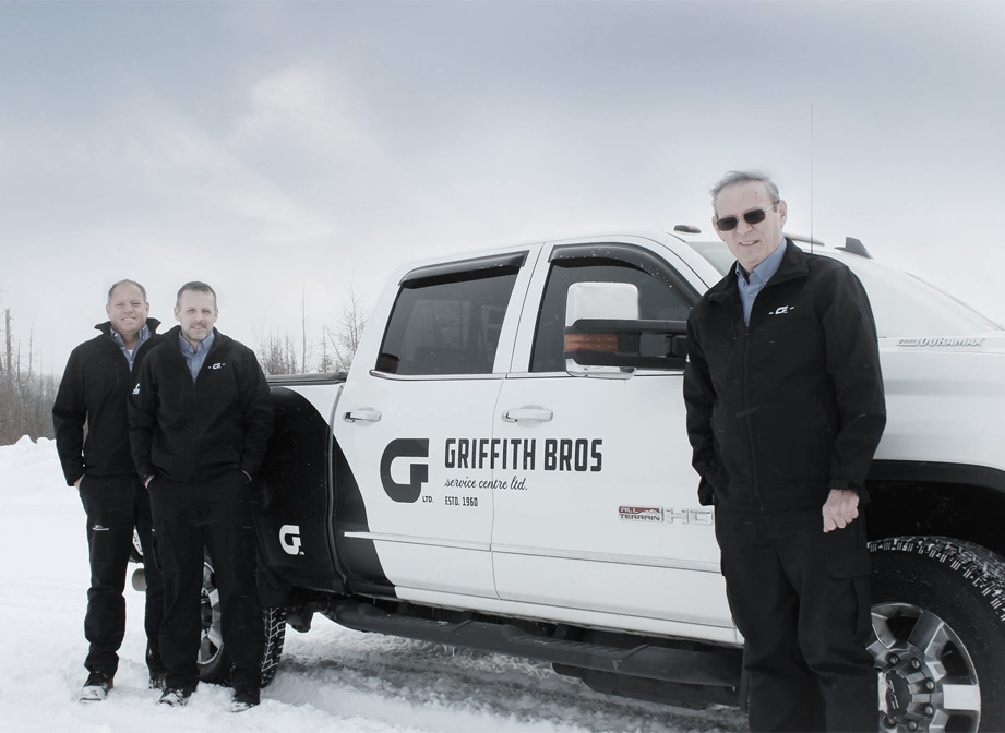 Griffith Bros. smiling staff in front of service truck